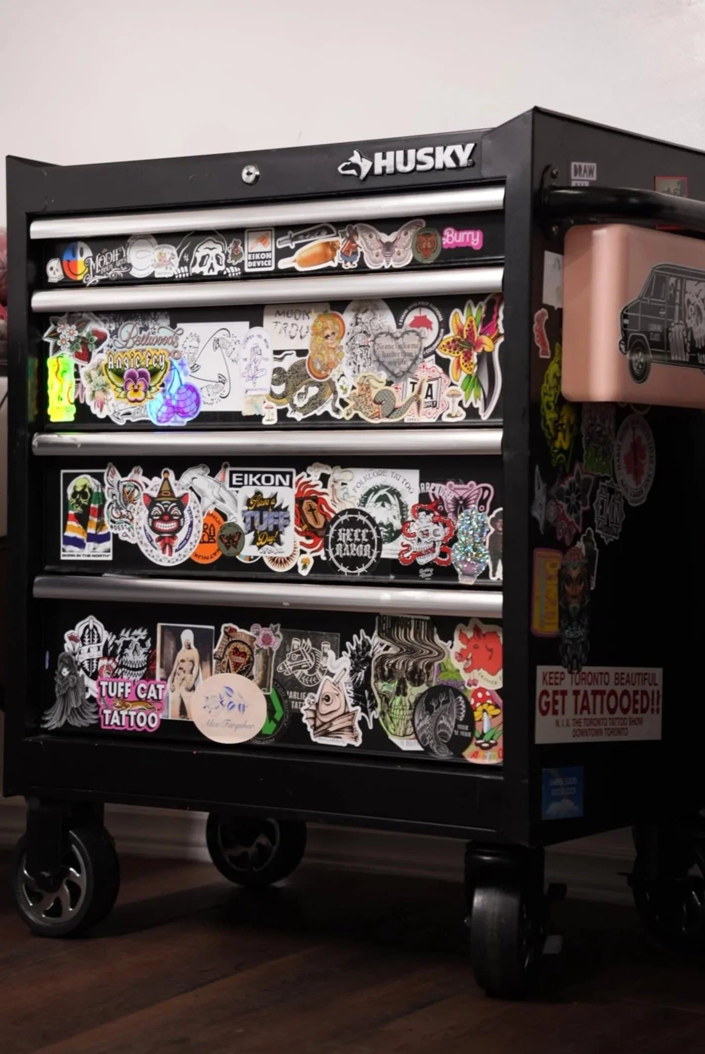 Rolling tool cabinet in a Halifax studio covered in tattoo industry stickers